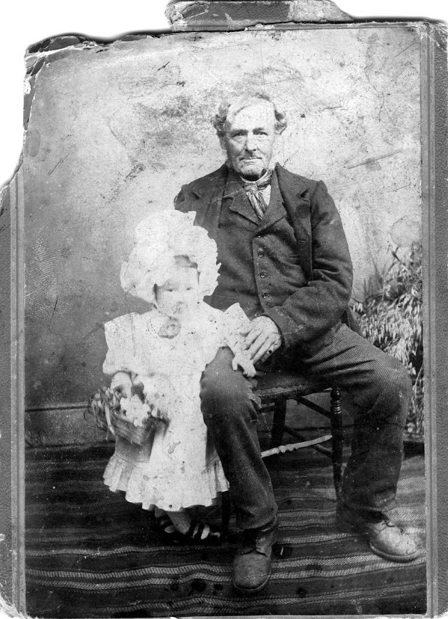 Studio portrait of Joseph Hitchman (born 1823 in Winderton), agricultural workman and his granddaughter Thistle May Hitchman (born 1901).  Photo c.1902 |  IMAGE LOCATION: (Warwickshire County Record Office) PEOPLE IN PHOTO: Hitchman, Joseph, Hitchman, Thistle May, Hitchman as a surname