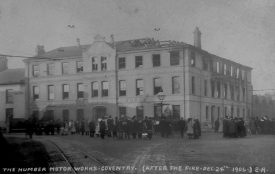 The Humber Motor Works, Far Gosford Street, after the fire of December 24th 1906. A crowd looks on as a charred building smoulders. | Express Photo Co., Rugby. Warwickshire County Record Office reference PH350/729