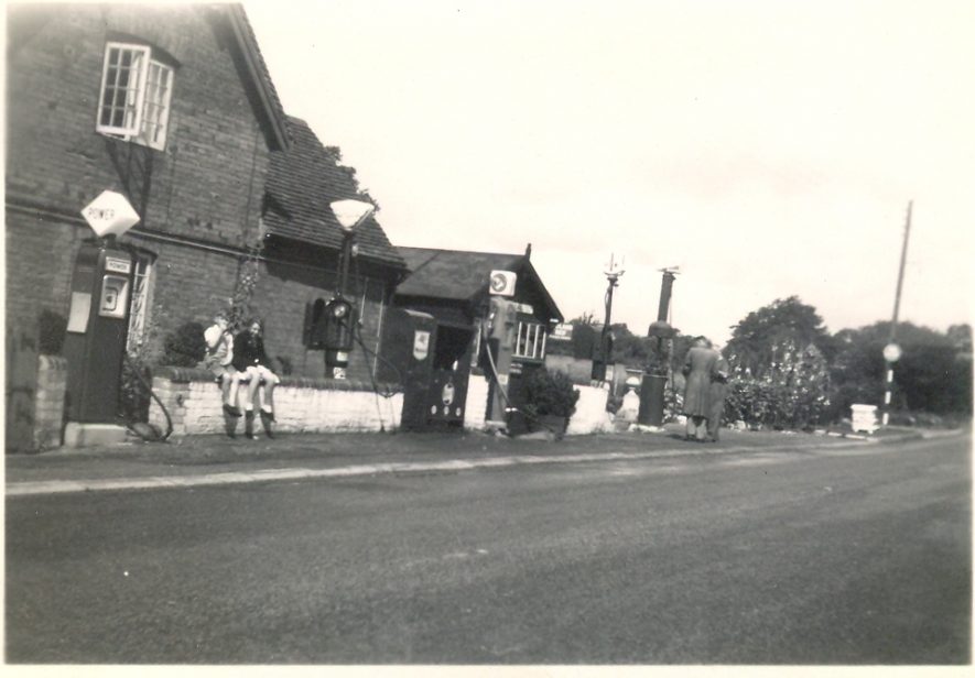 The filling station at Haseley, August 1950. A petrol pump with a riangular sign is in front of a house-type structure, that joins immediately onto the road. | Image courtesy of RT Bolton. Warwickshire County Record Office reference B.HAS.Bol(P)