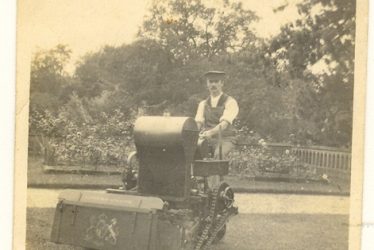 Wroxall. Gardener Using Large Petrol Powered Lawn Mower, Wroxhall Abbey