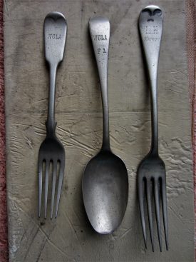 A spoon and two forks with inscriptions: WCLA; WCLA F1; LH Matron on a cream background material | Image courtesy of Anne Langley