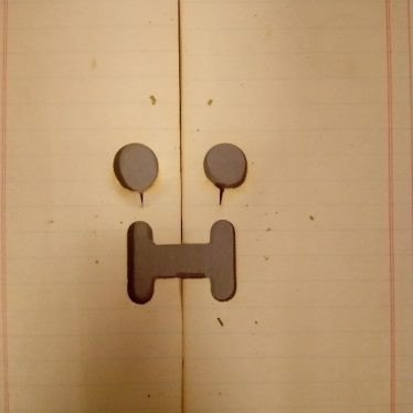 Holepunches in paper which look like a face and who we have named Wilson | Image courtesy of Warwickshire County Record Office