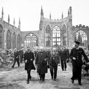 Winston Churchill walking through the ruined nave of Coventry Cathedral, after it was severely damaged in the Coventry Blitz of 14–15th November 1940 | Image taken by Capt Horton, War Office official photographer, Courtesy of Imperial War Museum. H_14250 Imperial War Museum Archives