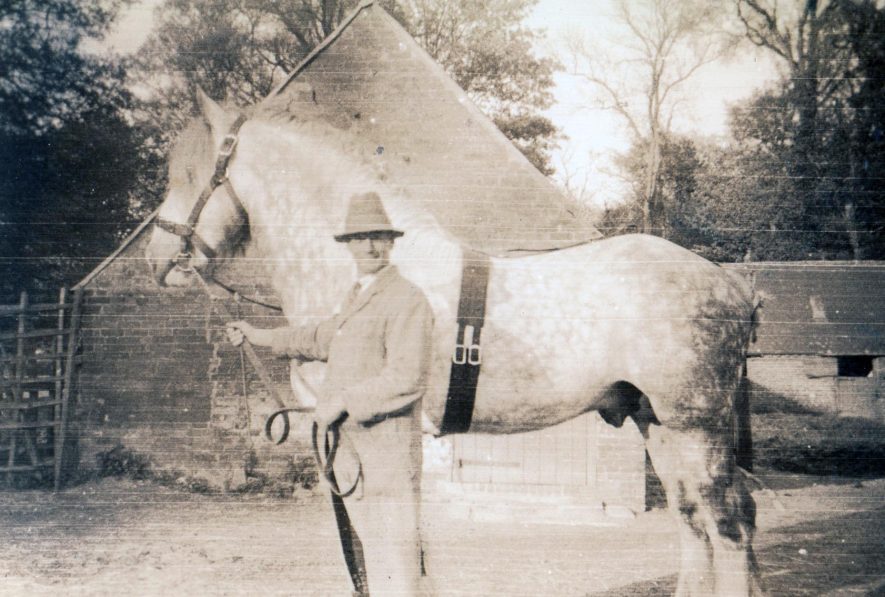 Wilfred Victor Sivyour with 'heavy horse' at The Stalls Alscot Park c.1943 He was a shepherd and his wife Ethel looked after and milked a small number of Jersey cows that supplied the Main House with milk, butter and cream. The Stalls are now used as a retail outlet and cafe. | Image courtesy of Derek Bull
