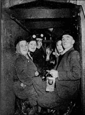 The doctors and nurses in the pit cage, waiting to go down the shaft. | Birmingham Evening Despatch, January 19th 1952, page 1